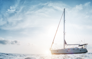 sailboat at anchor with sunshine on the water.